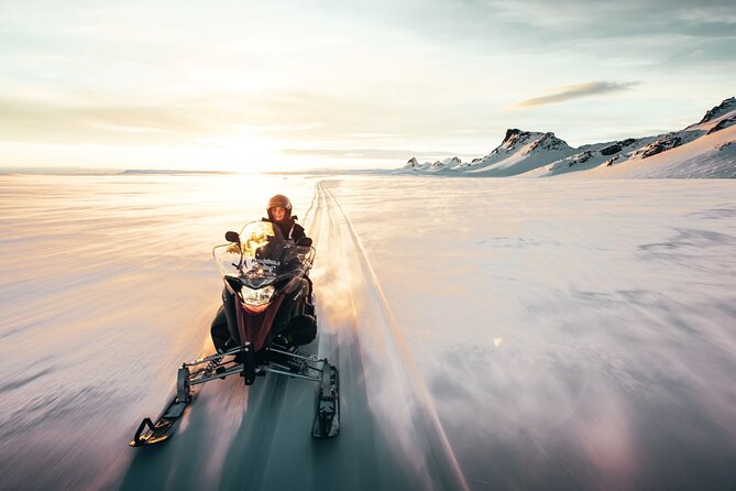 A rider crossing Langjökull in warm evening light