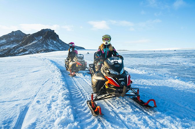 Tandem riders on a guided Langjökull snowmobile tour