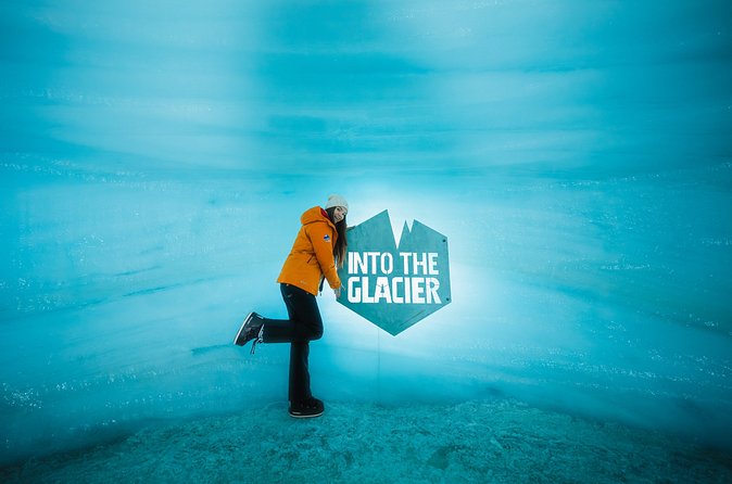 A visitor inside the blue ice of the constructed Into the Glacier tunnel on Langjökull